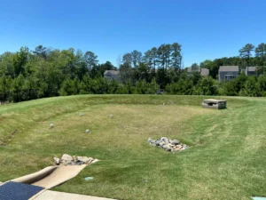 A stormwater control measure (SCM) area with full grass coverage.